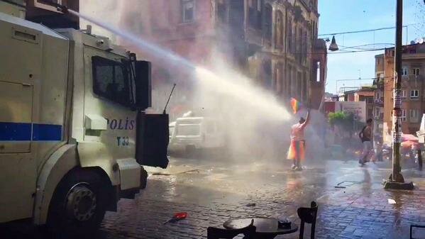 The police turn a firehose on a woman expressing her support for LGBT rights.
